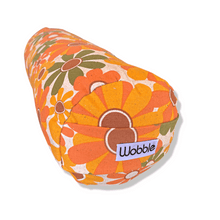 A collection of colorful Tiny Yoga bolster pillows with various patterns.