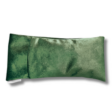 Green velvet pillow on a white background